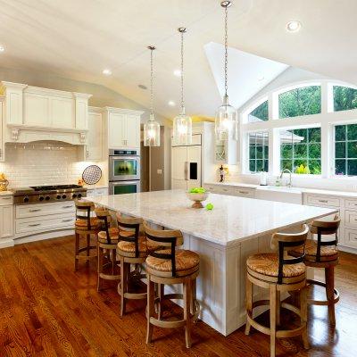 Gourmet Kitchen with arched window and large island with 6 barstools